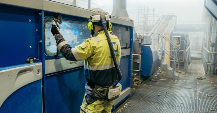 Syklo’s waste sorting plant operator inspects the wind sorter.